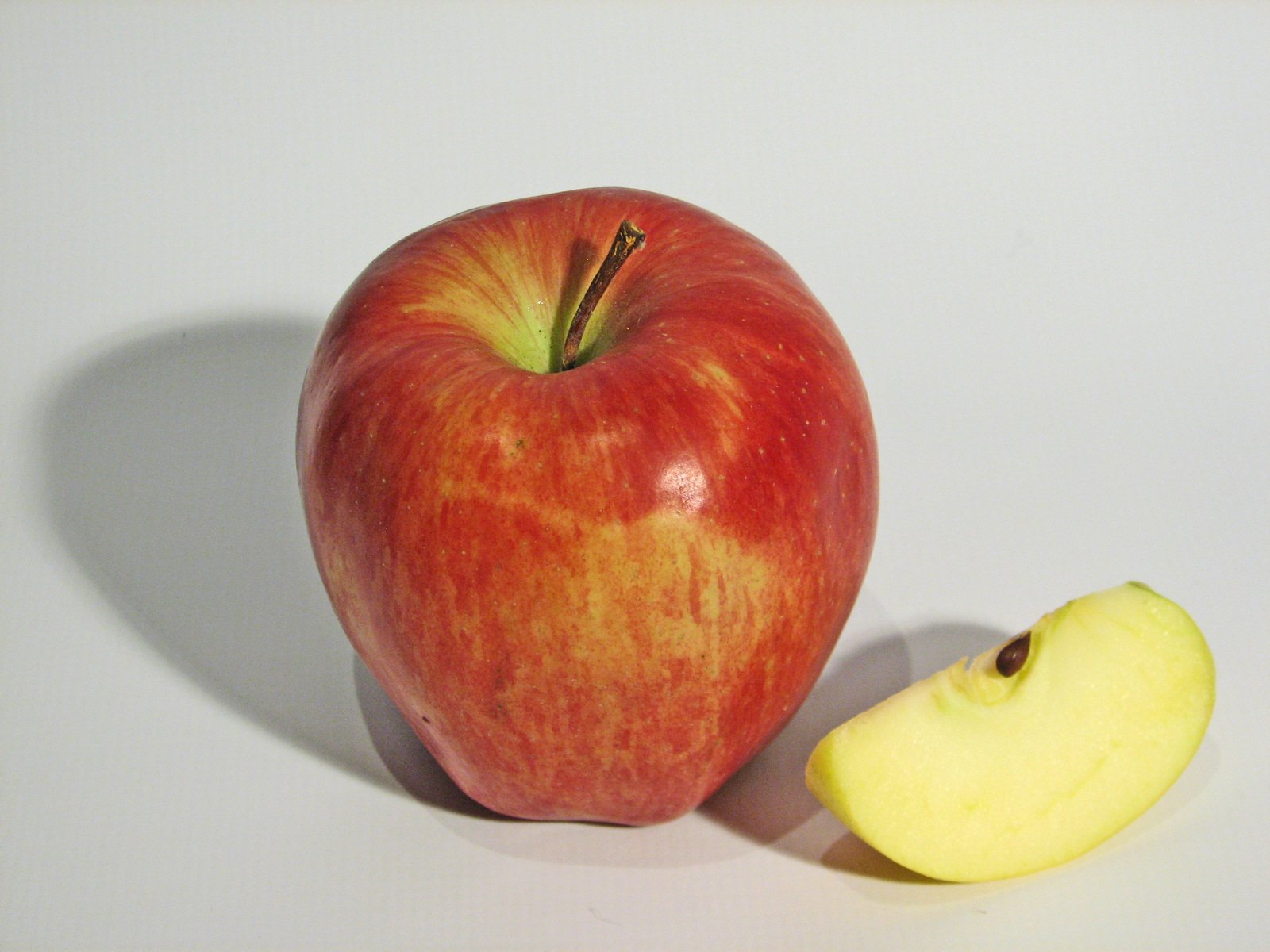 an apple and a half of the apple are shown