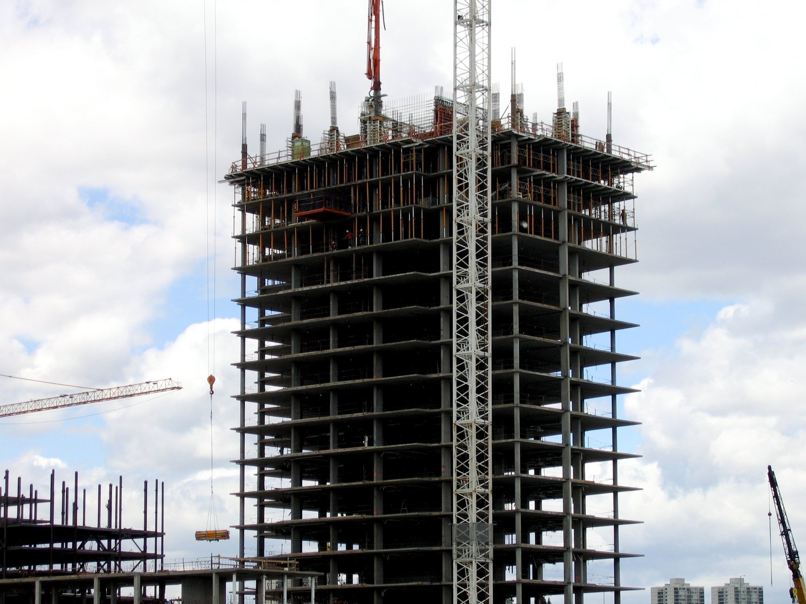 a large tower under construction with lots of cranes