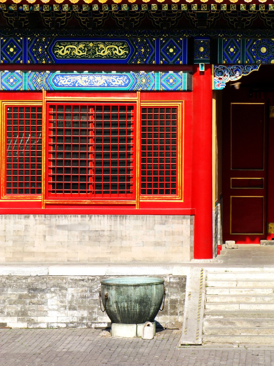 the front view of a building with red and blue window frames