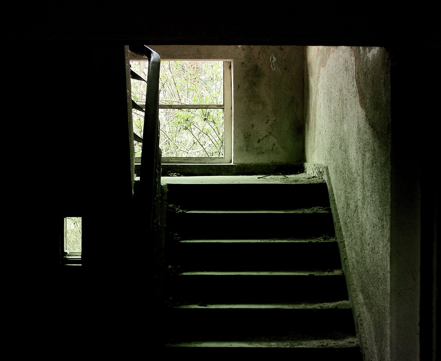 the inside of a building with a stairway leading to an open window