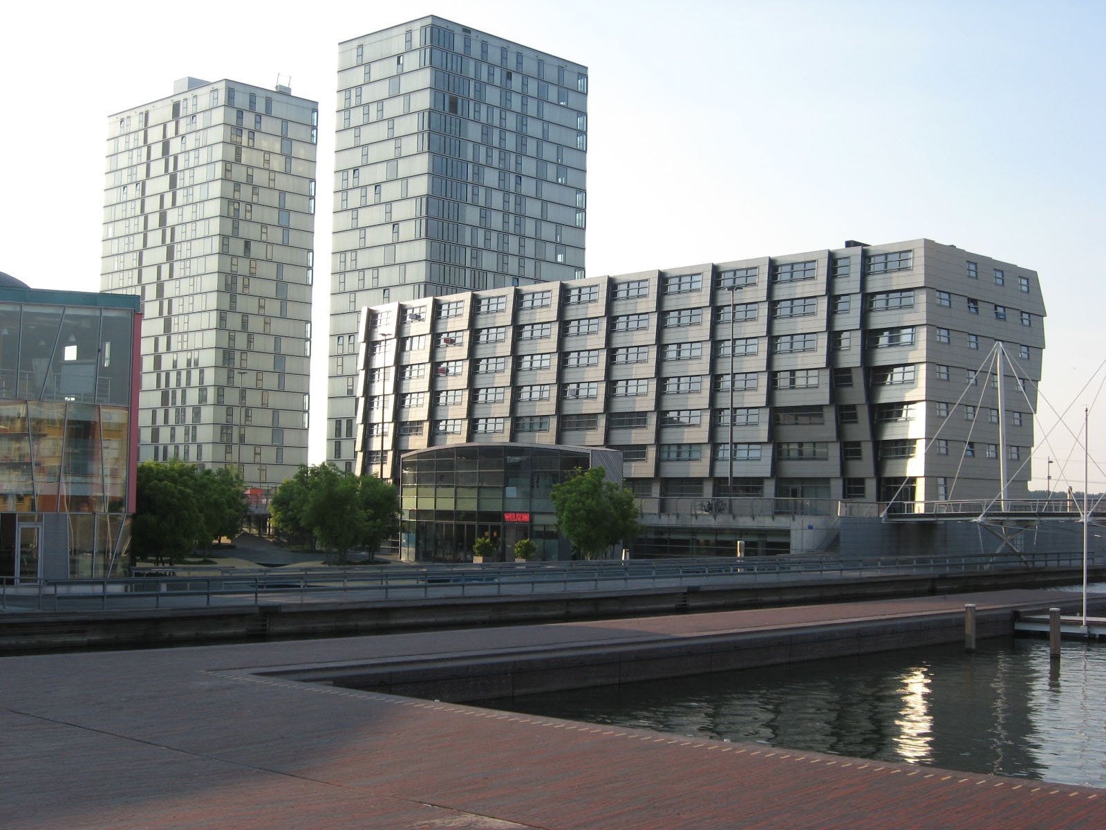 two buildings in the middle of a waterway next to another building