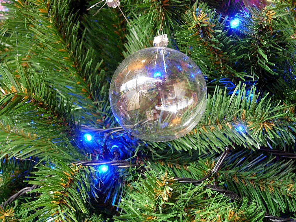 a tree is decorated with christmas lights and ornaments