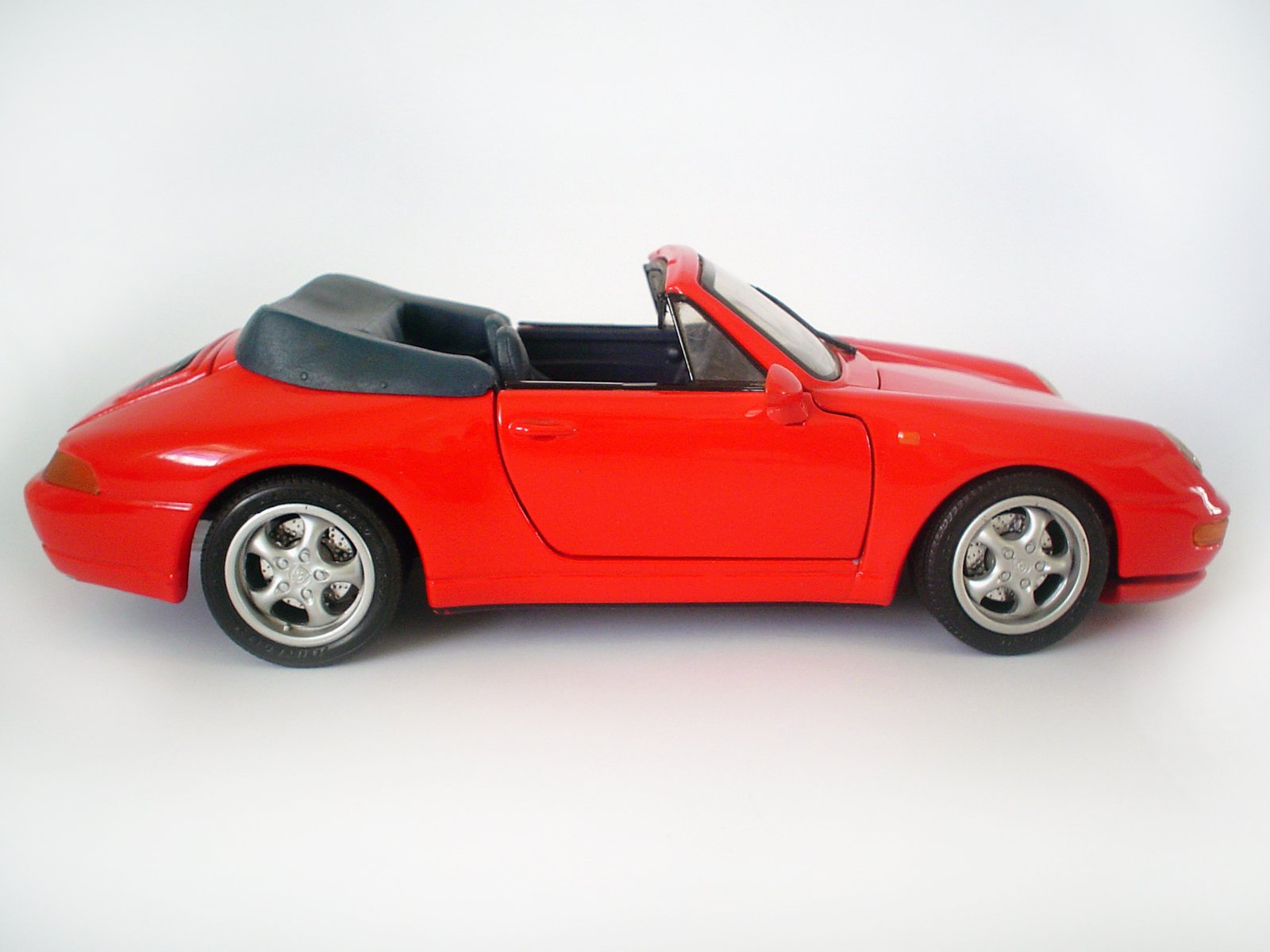 a toy red sports car parked in a room