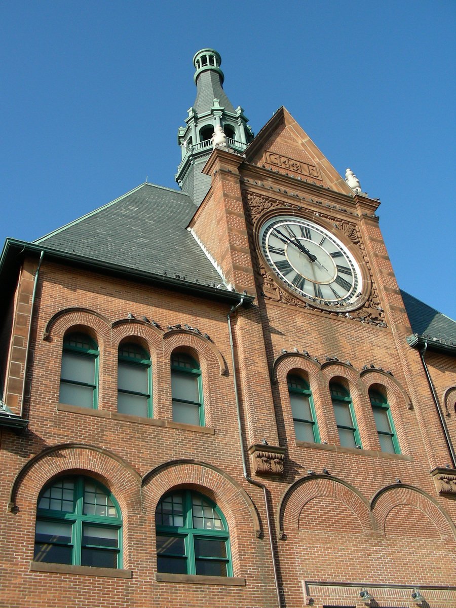 a clock tower is pictured at the top of this building