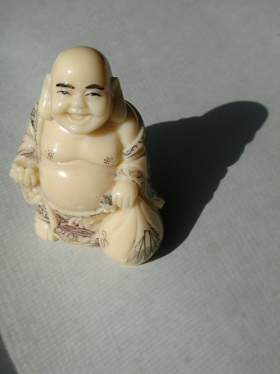 a small figurine is sitting in the middle of the floor