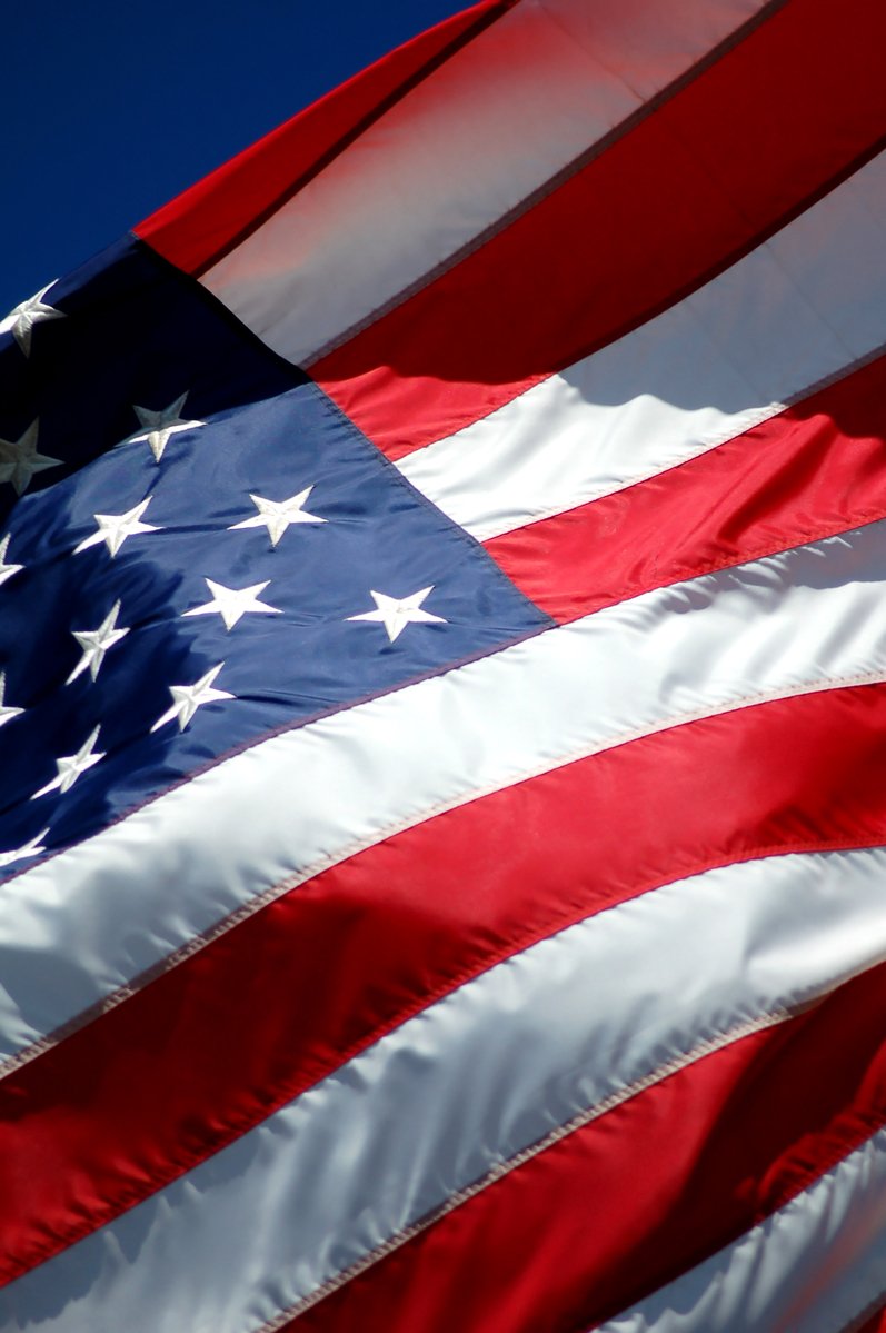 a closeup of an american flag that is being flown