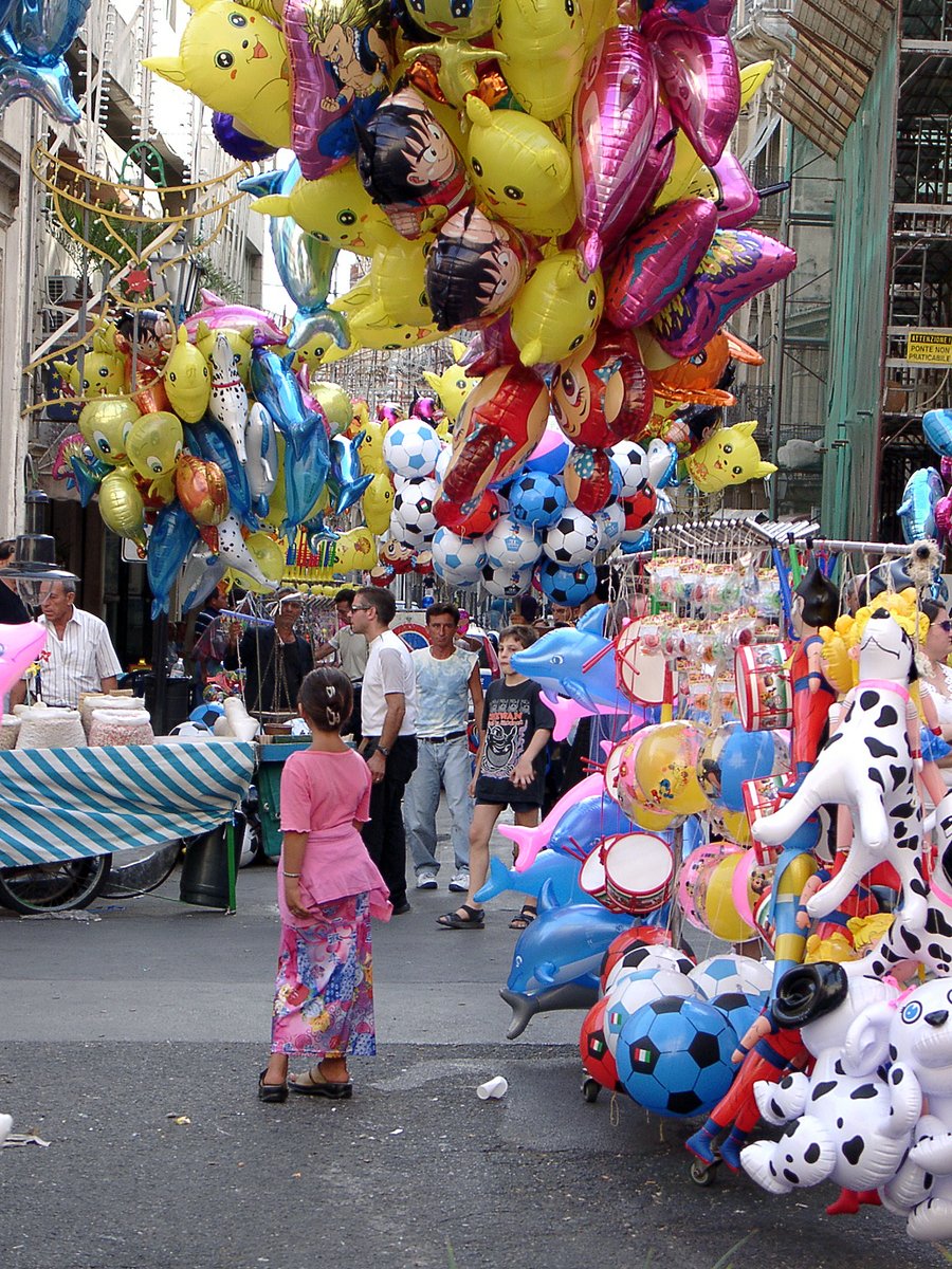 the people are selling their gifts and balloons