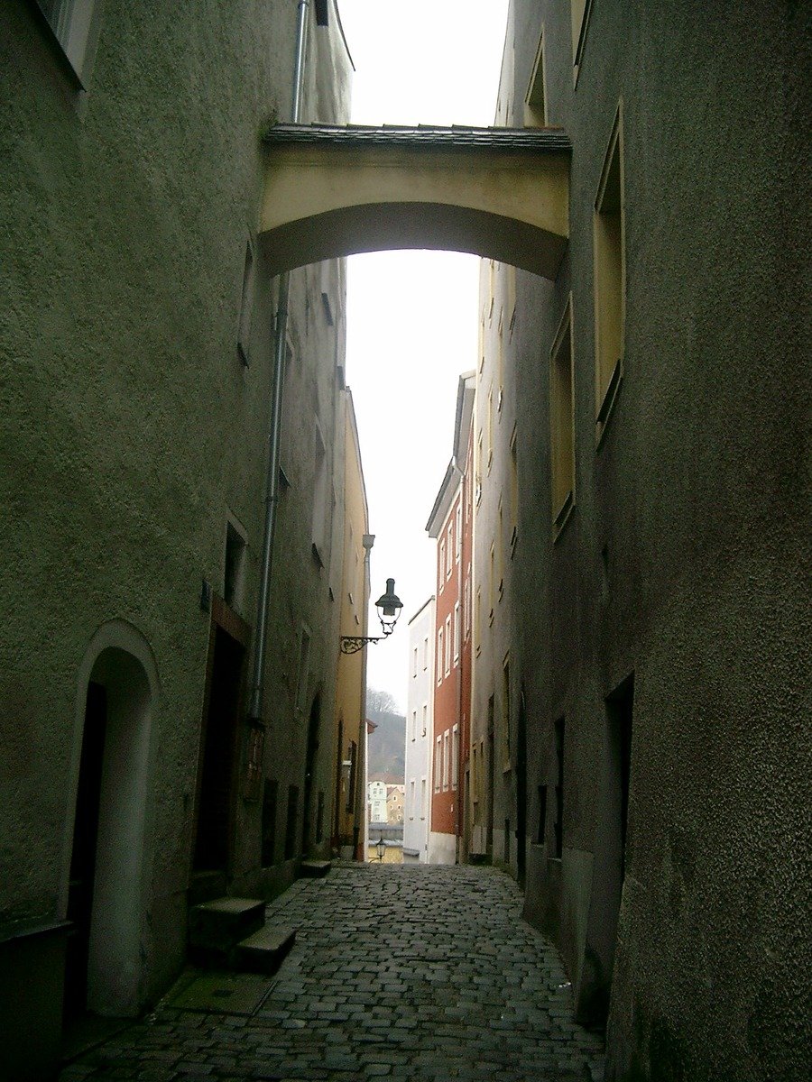 a narrow street has many stone buildings on it
