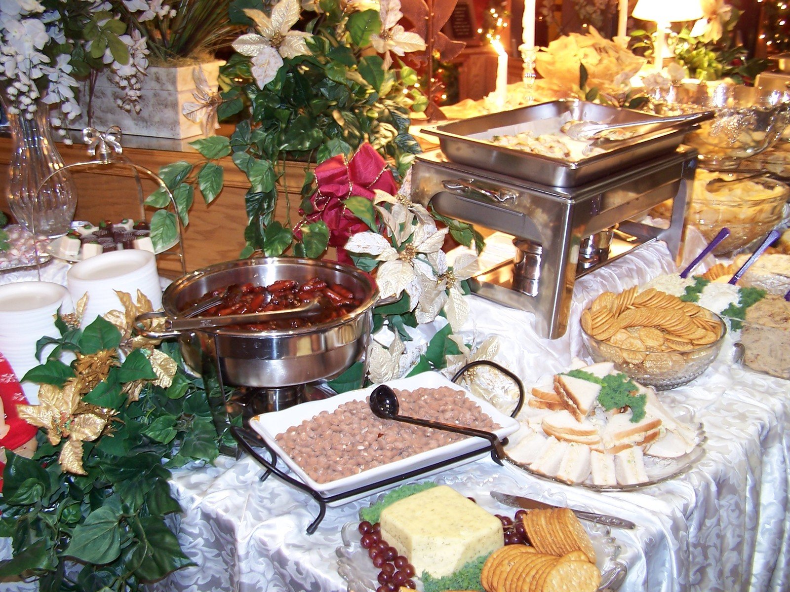 a buffet table has bread, ers, meats and fruits