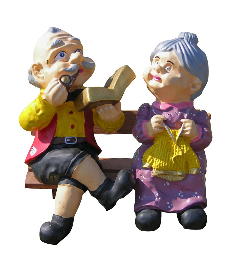 a statue of an old man and woman sitting on a bench