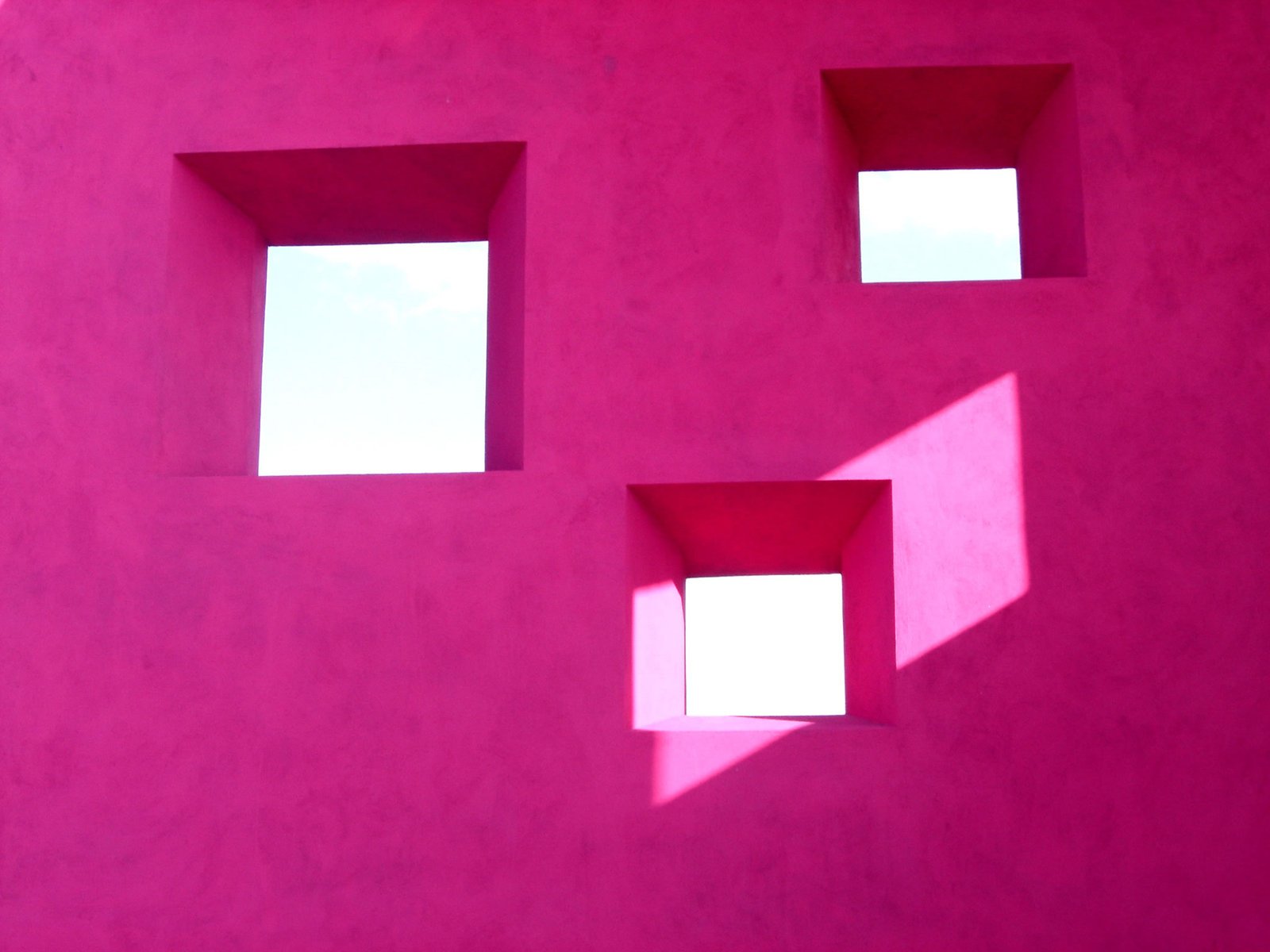 an abstract picture of three square windows on pink background