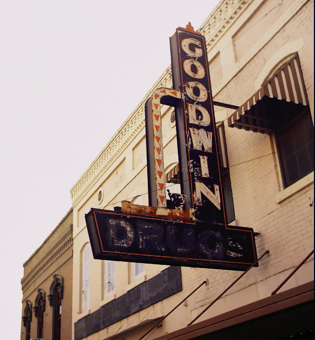 a large sign hangs on the side of a building