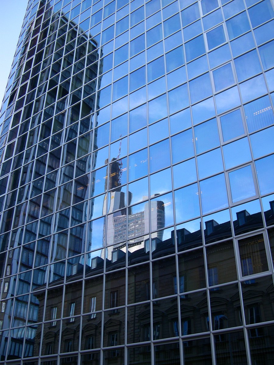 the reflection of an office building in a window