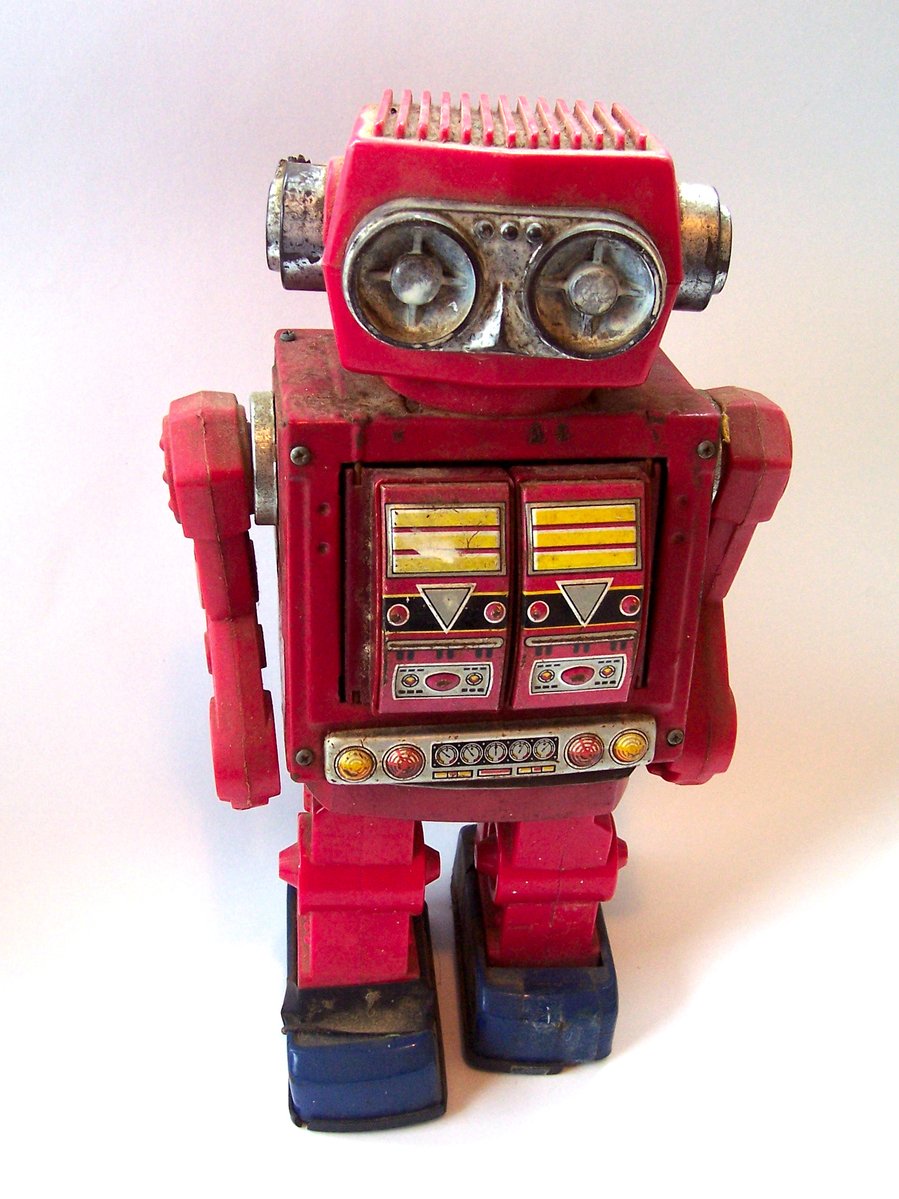 there is a small red robot toy
