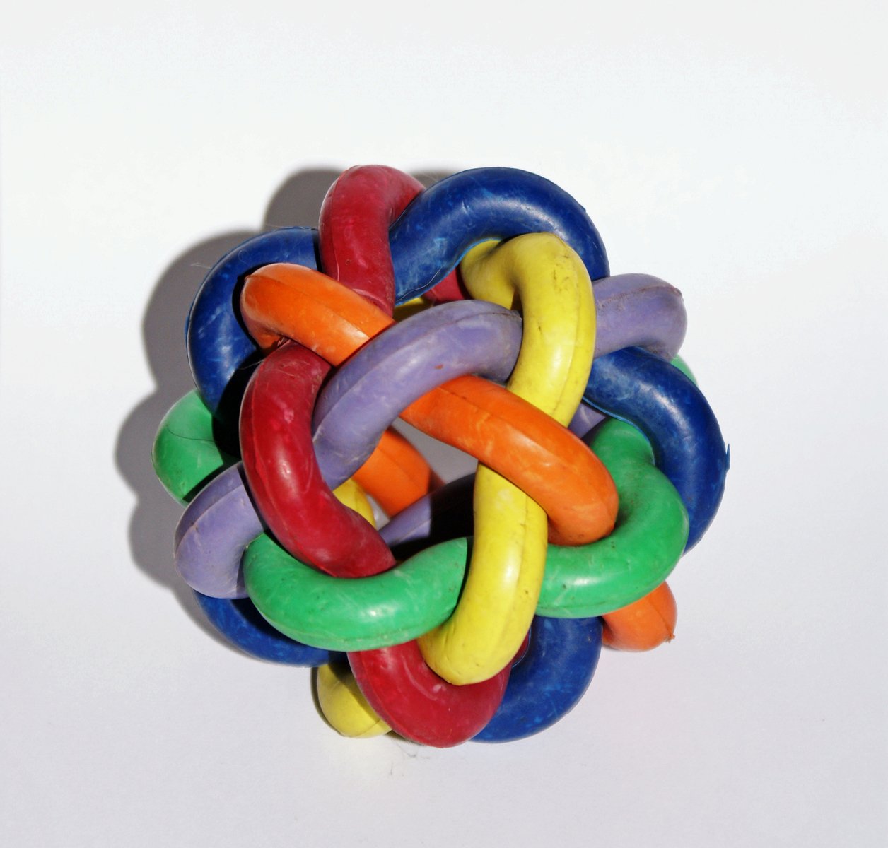 colorful toy rings arranged in the shape of an apple