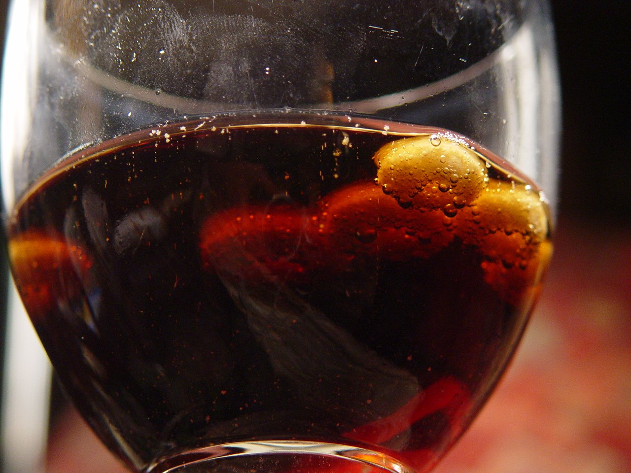 closeup po of wine in glass with orange