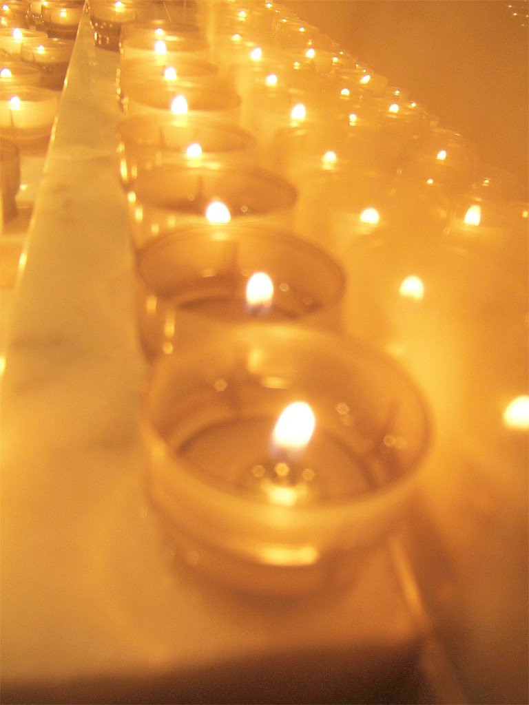 lit candles sit on a counter to make a candlelight ceremony
