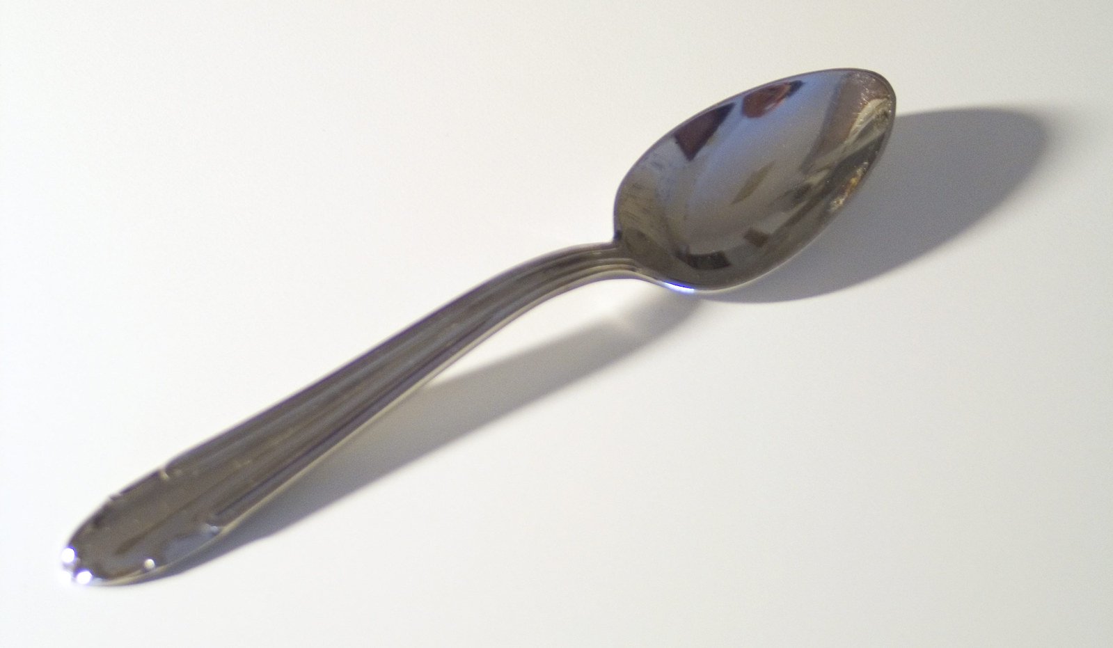 an elegant spoon is resting on a table