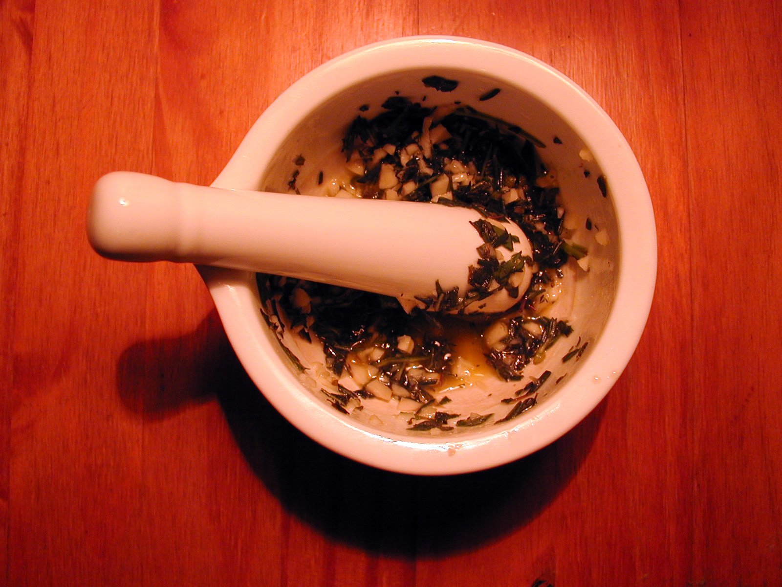 a small white bowl with a spoon inside of it