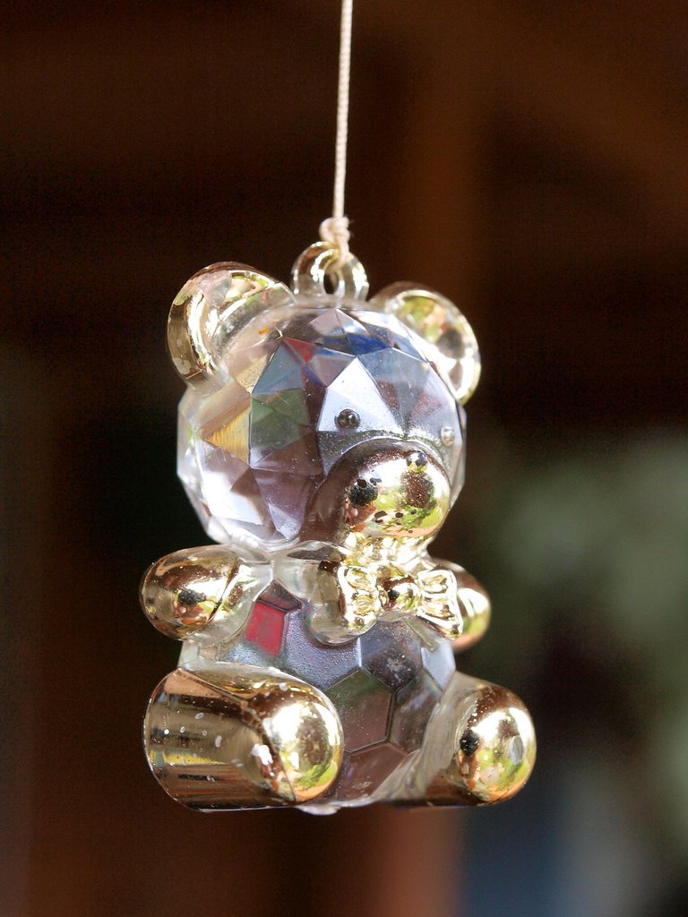 there is a crystal teddy bear hanging on the string