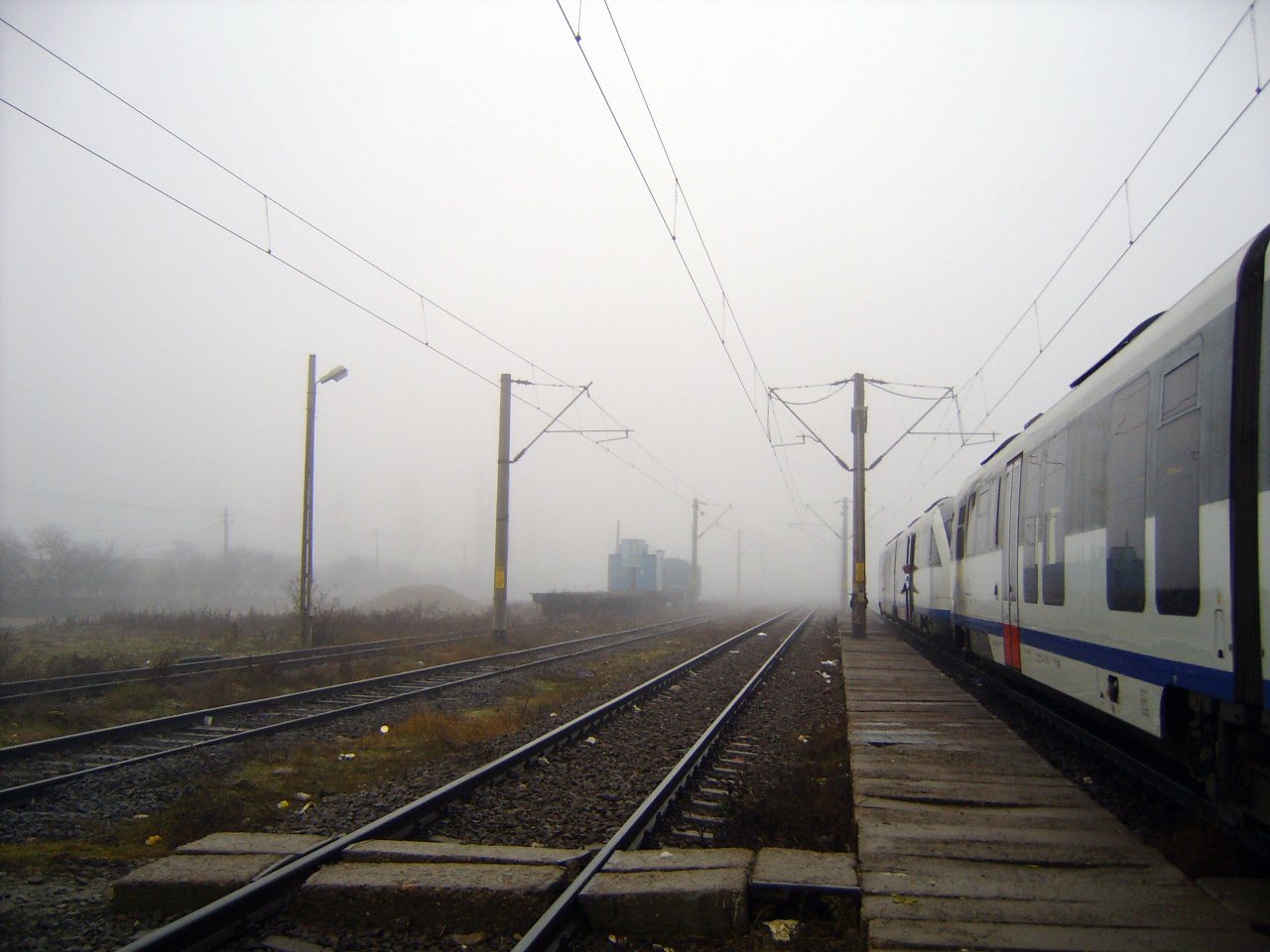 a train on a track in the fog