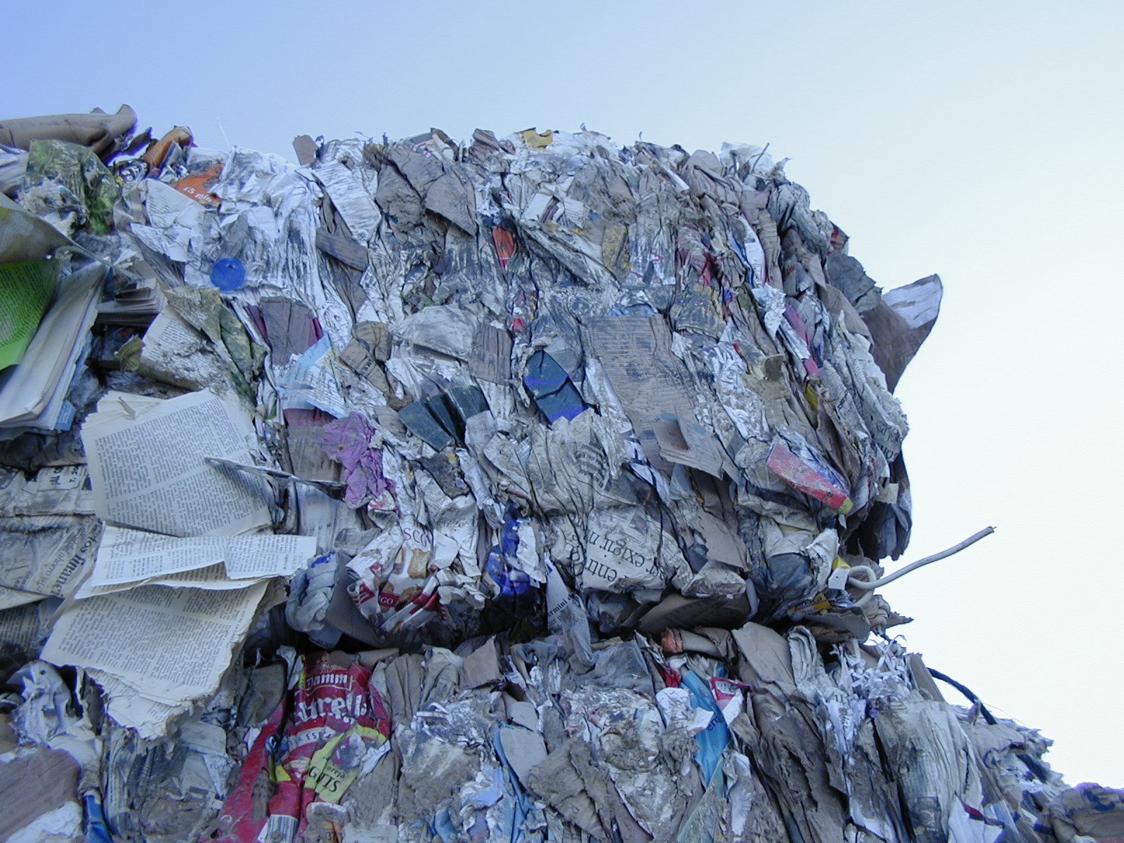 a large pile of papers is shown against a blue sky