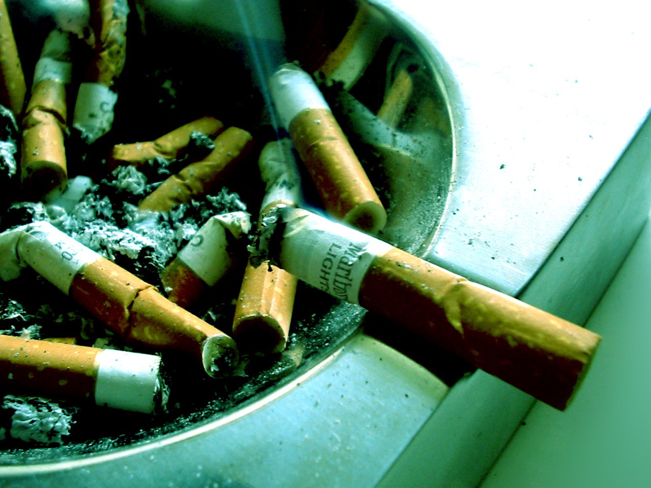 some cigarettes sitting in a metal bowl