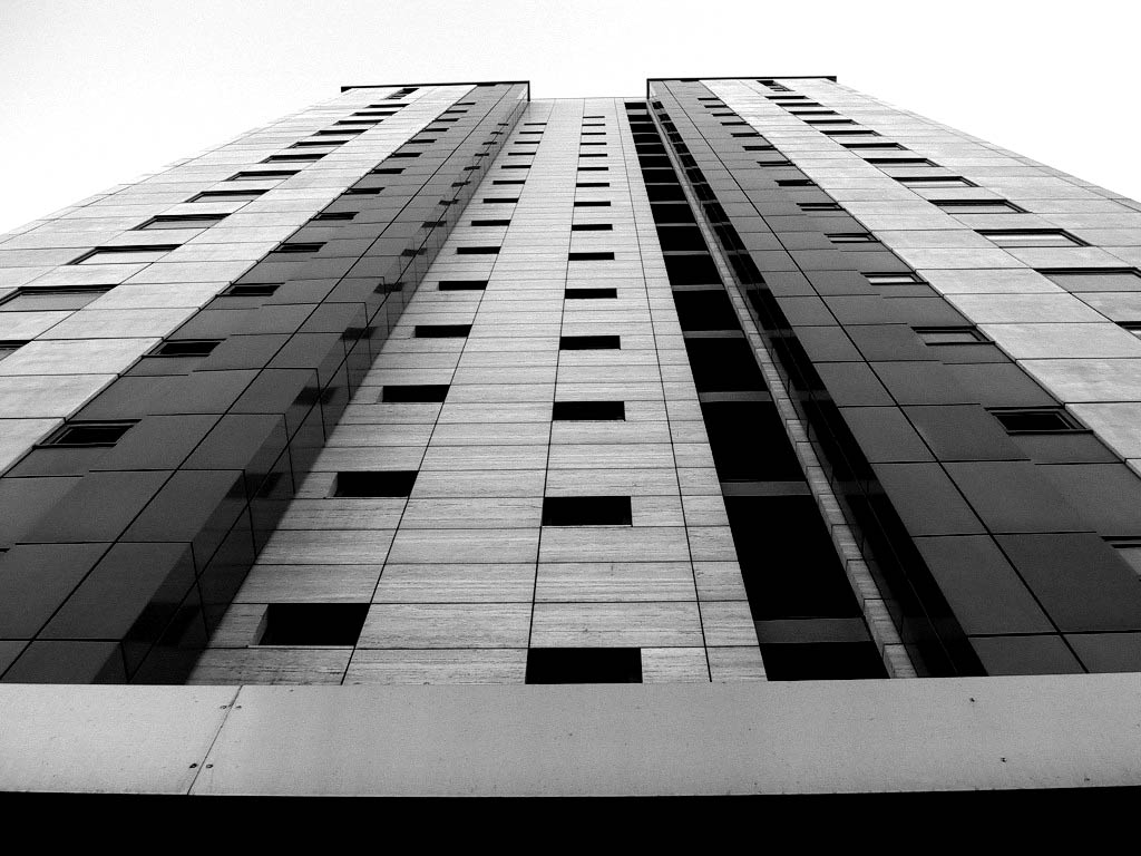 looking up at a tall building with multiple windows