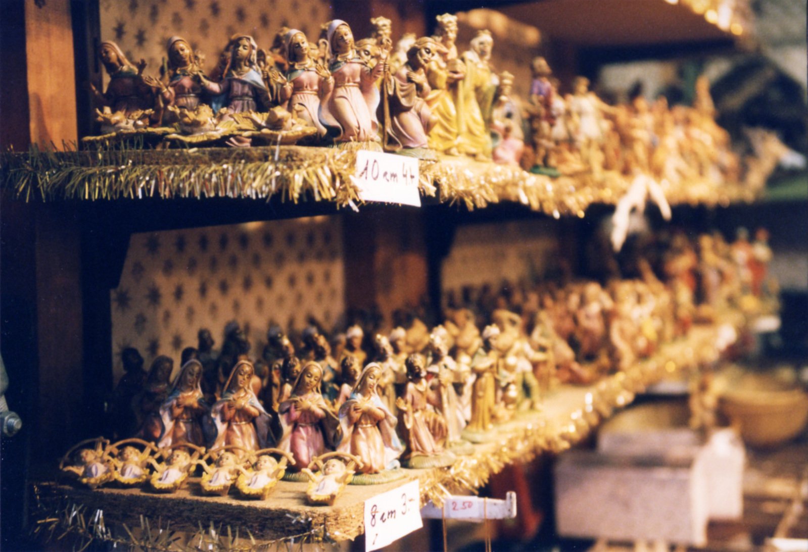figurines of different sizes sitting on shelves at a store