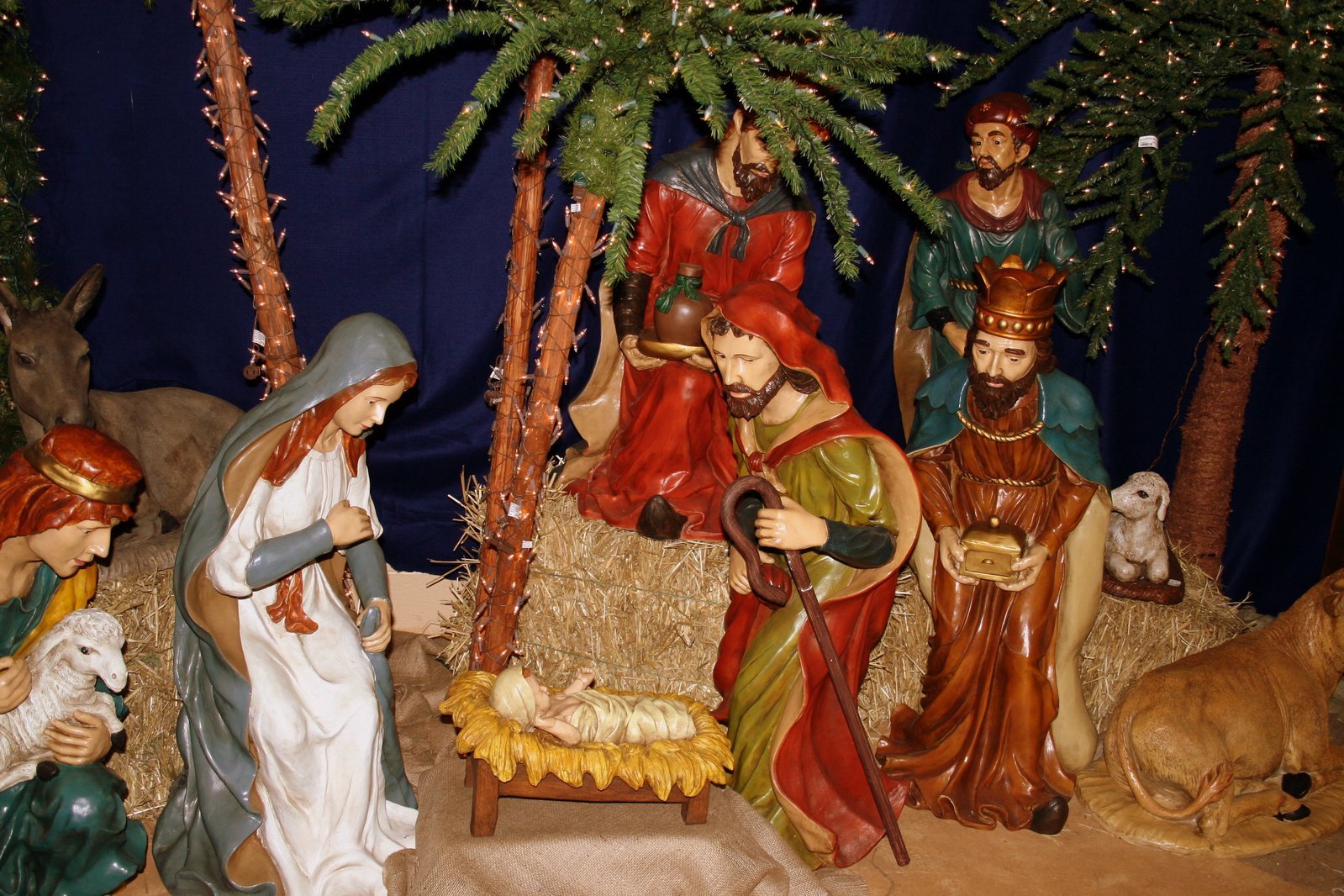 a nativity scene with figures and a dog