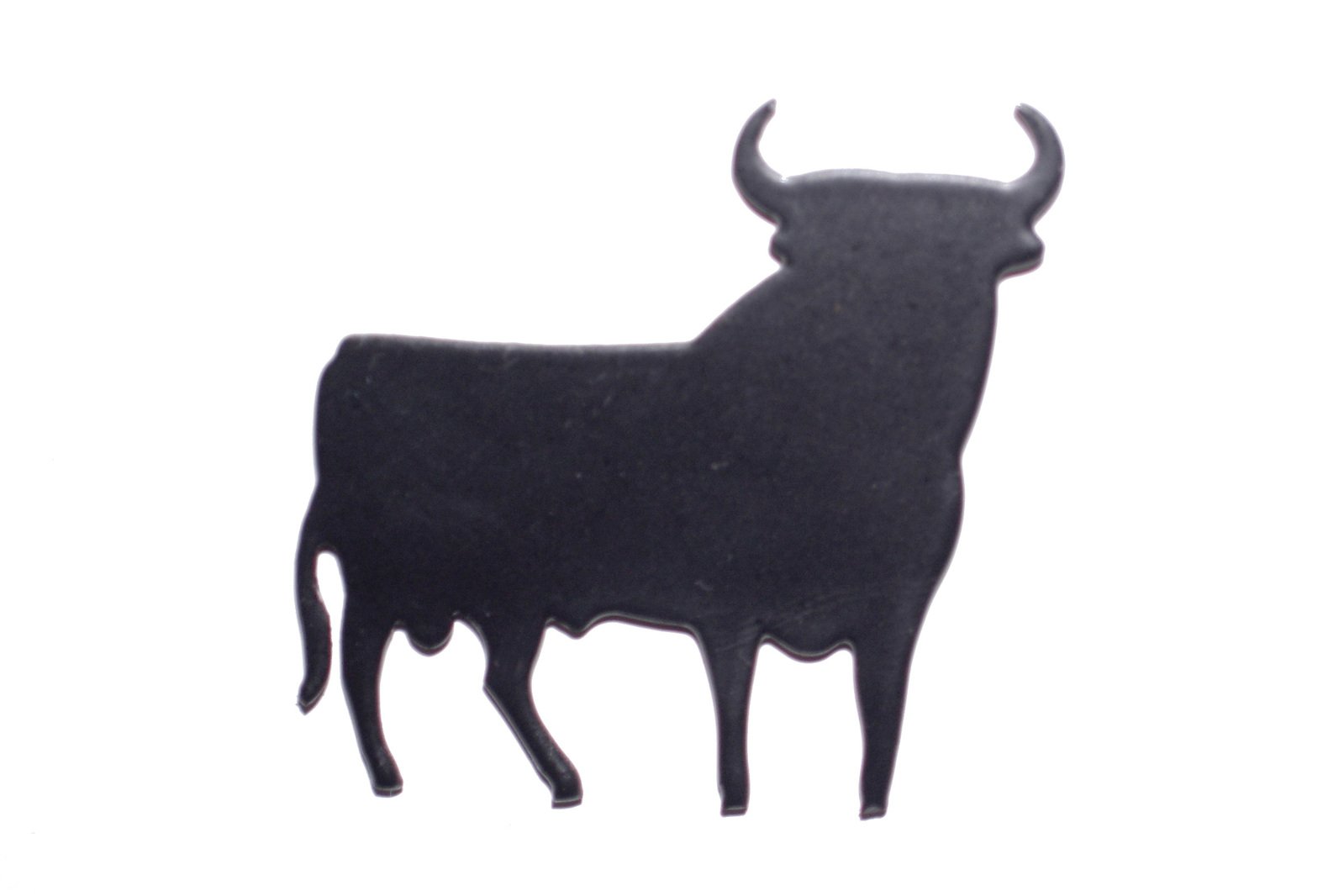 a bull with two horns standing on a white surface