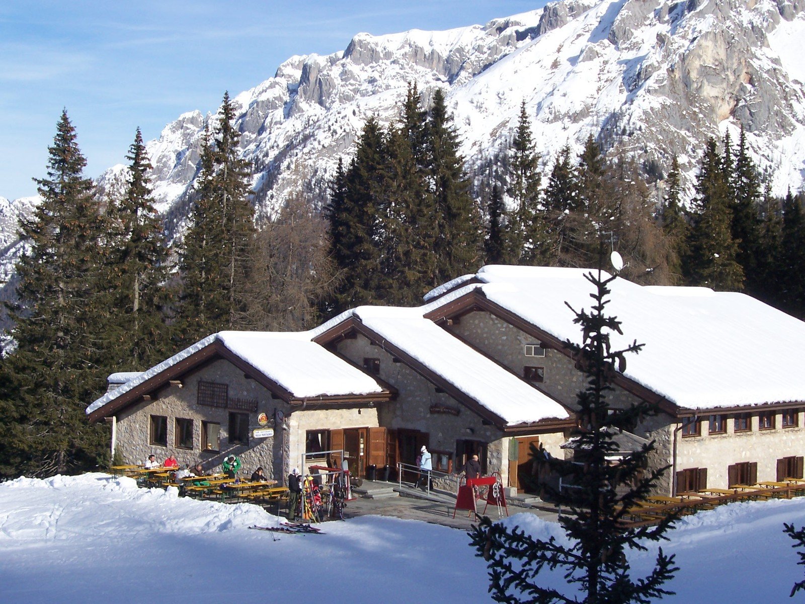 a lodge in the mountains on a sunny day