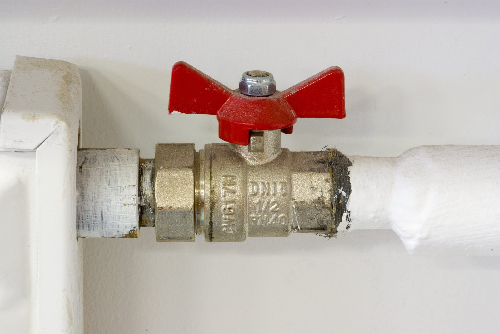 a close up of a red handle attached to a pipe