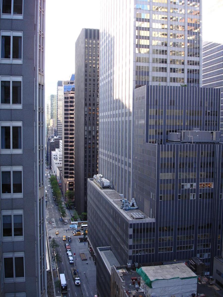 a cityscape of skyscrs along an intersection of a street