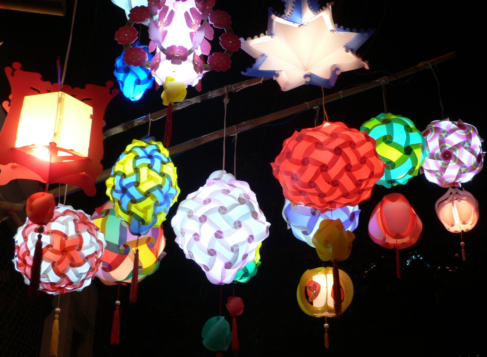 many different lanterns hanging on the ceiling