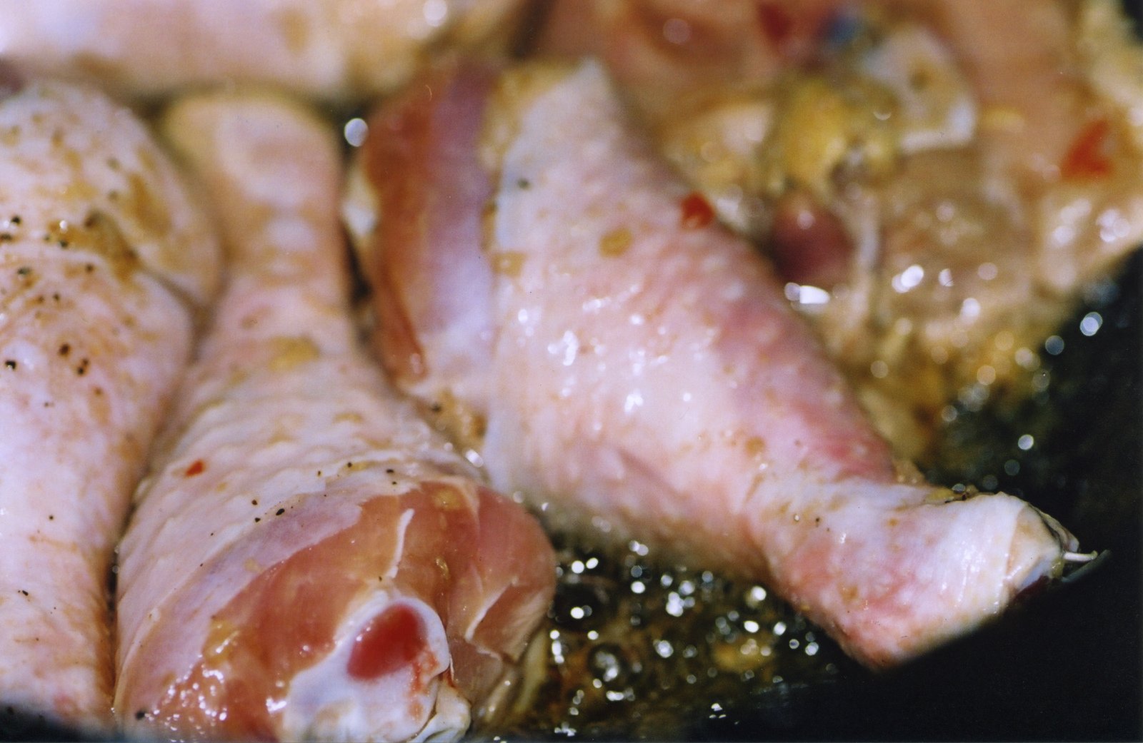 pork in a pan being cooked with pepper