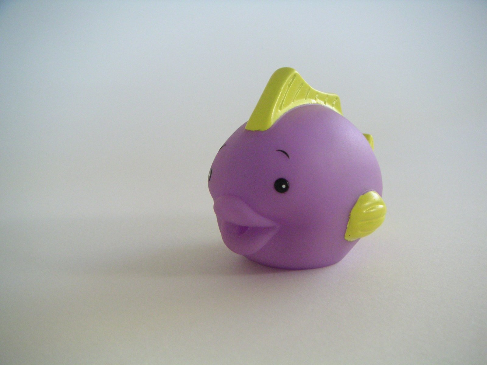 there is a toy purple and yellow fish