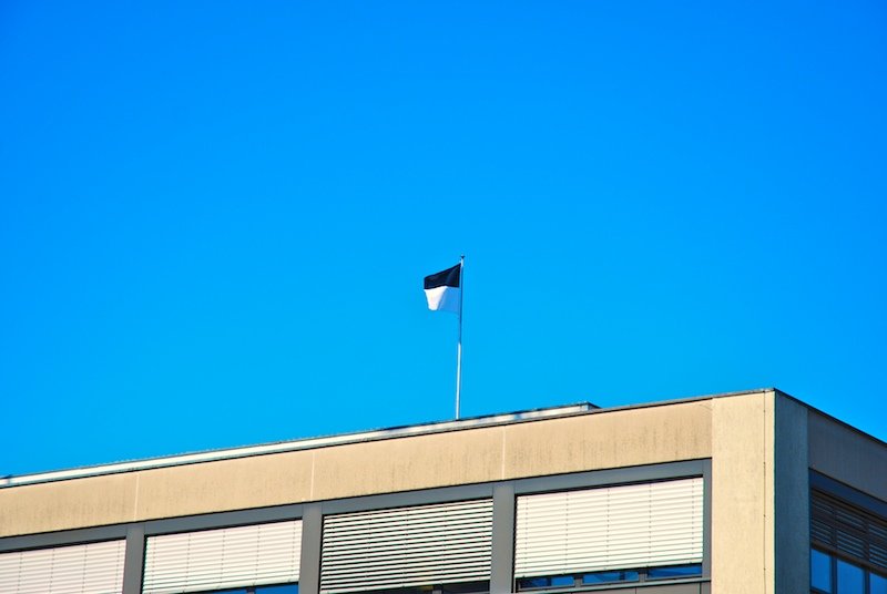 a flag is flying from top of a building