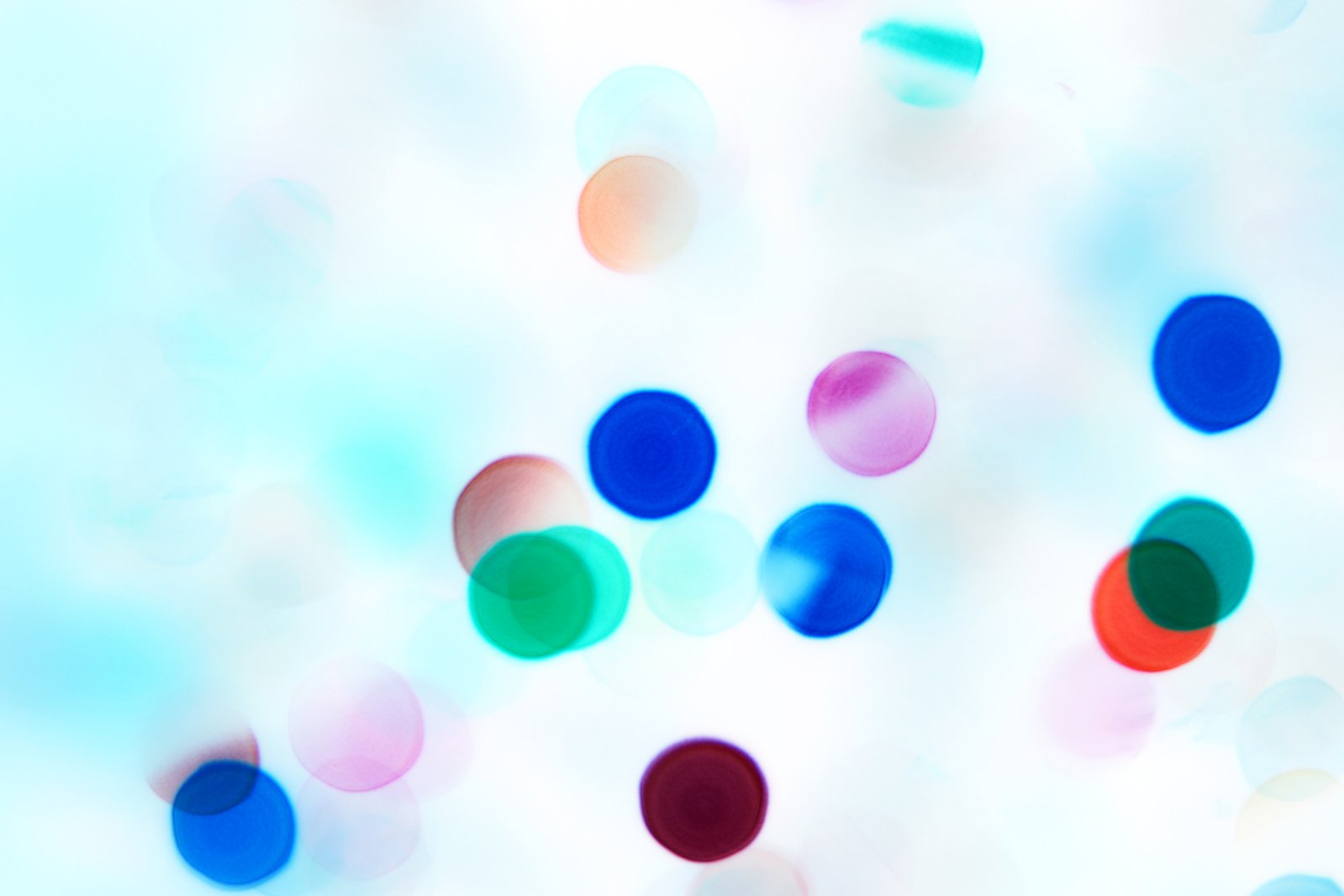 multi - colored circles and small spots of light blue background