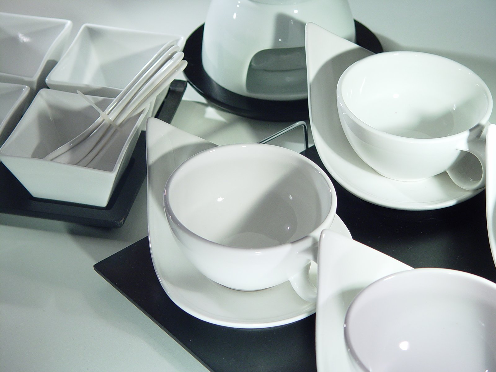 a table is piled up with different dishes and cups