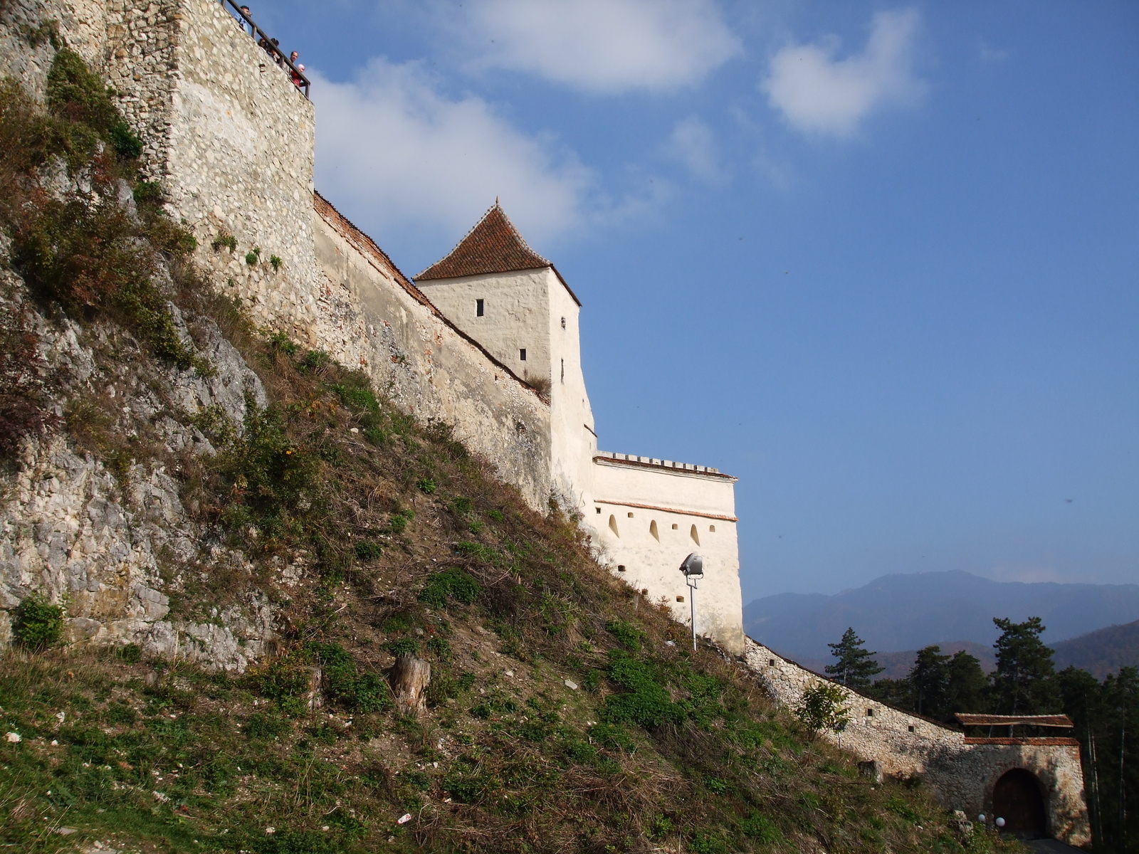 a tall, stone castle wall with a steep climb up