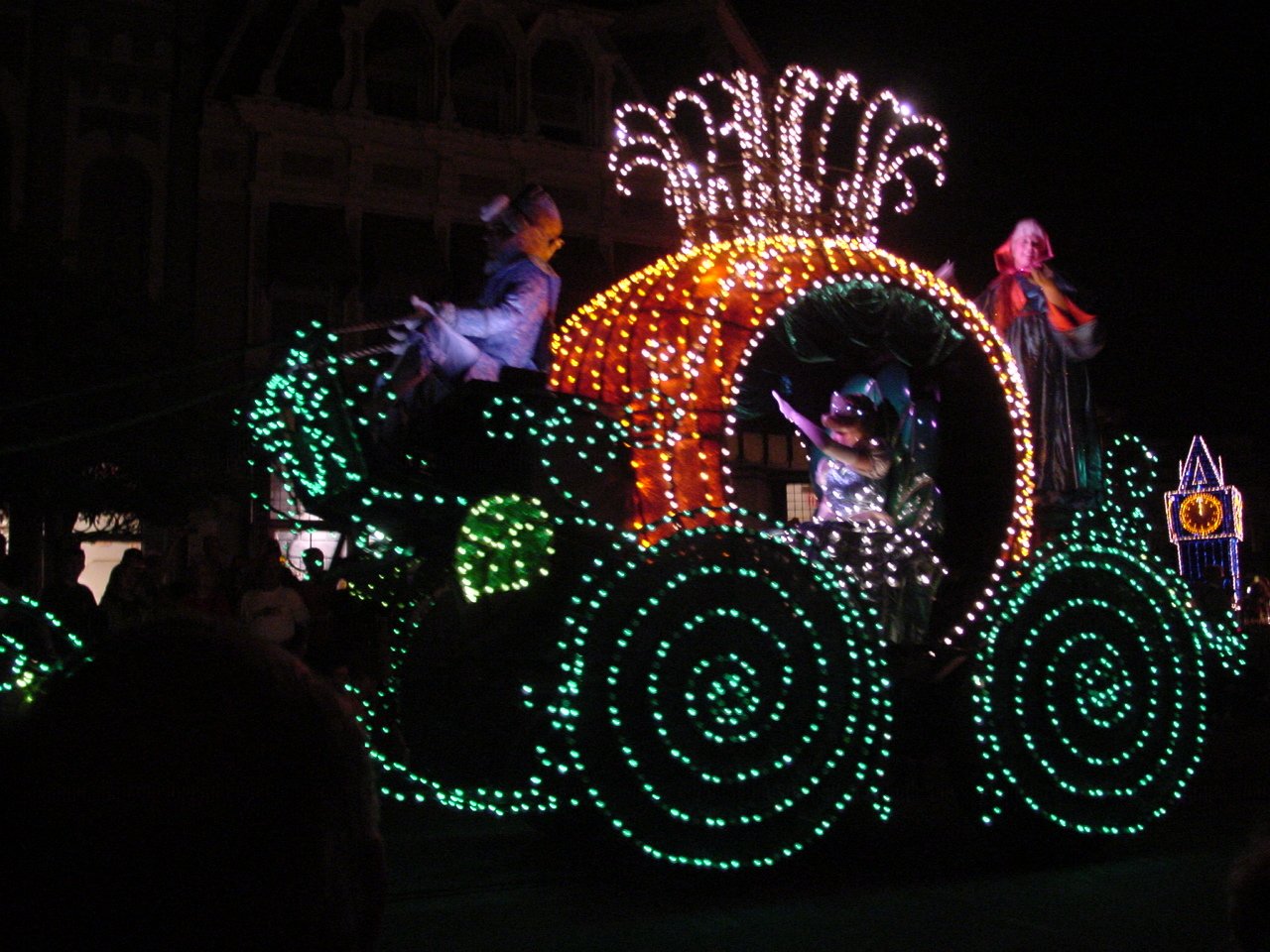 lighted train at a carnival filled with people