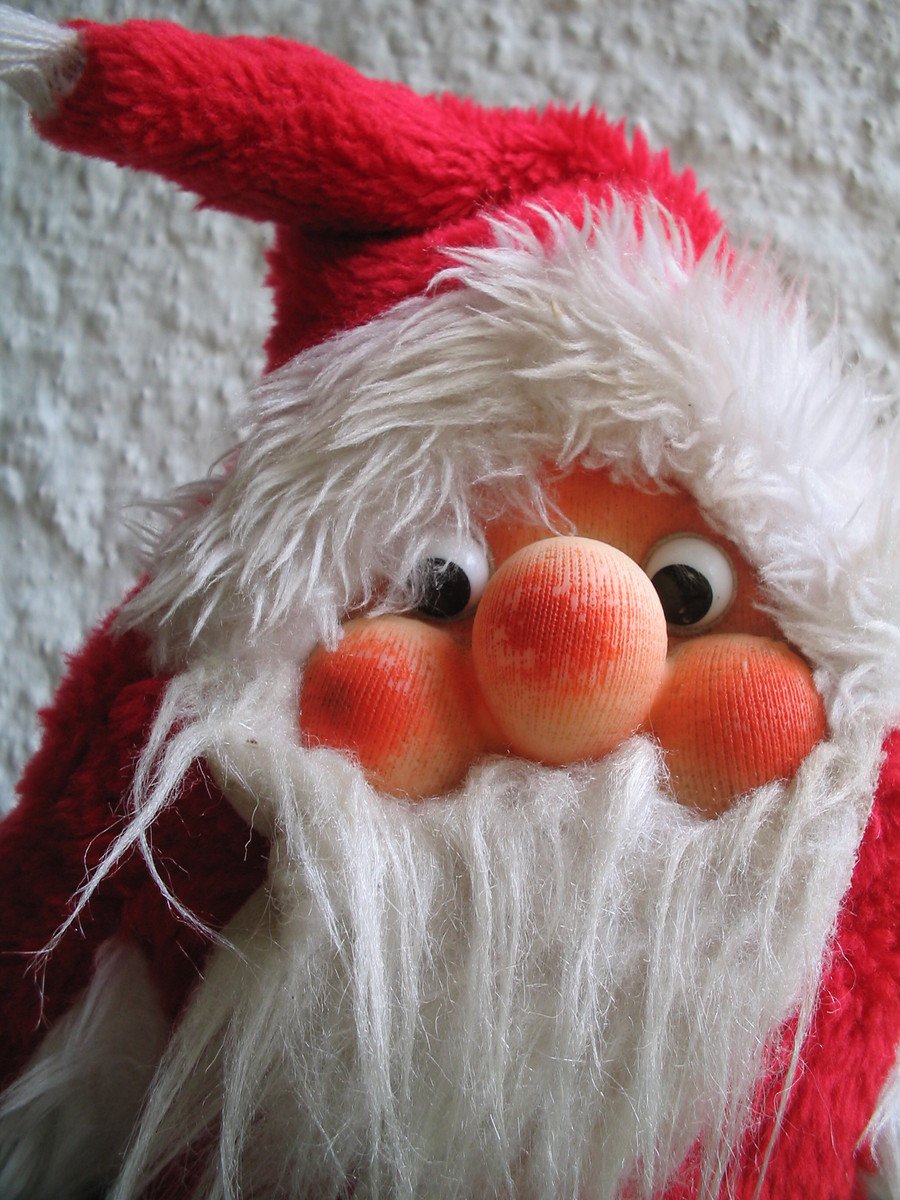 a close up of an old fashion santa claus toy