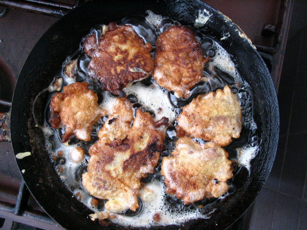 a pan with fried meat on it in oil