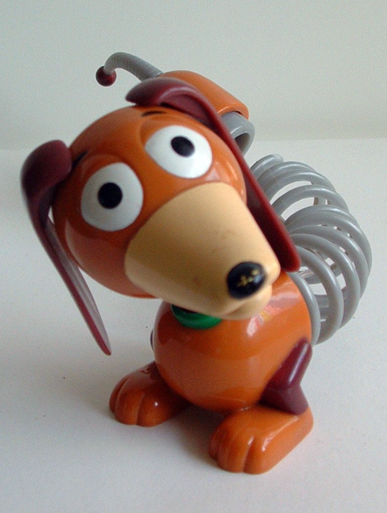 a dog figurine sitting on a table next to a knife