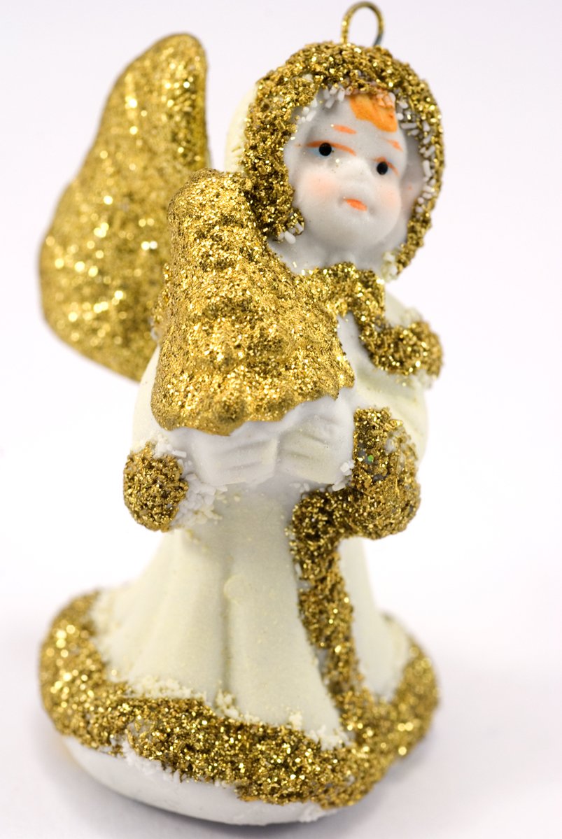 an angel ornament with gold wings and a white dress