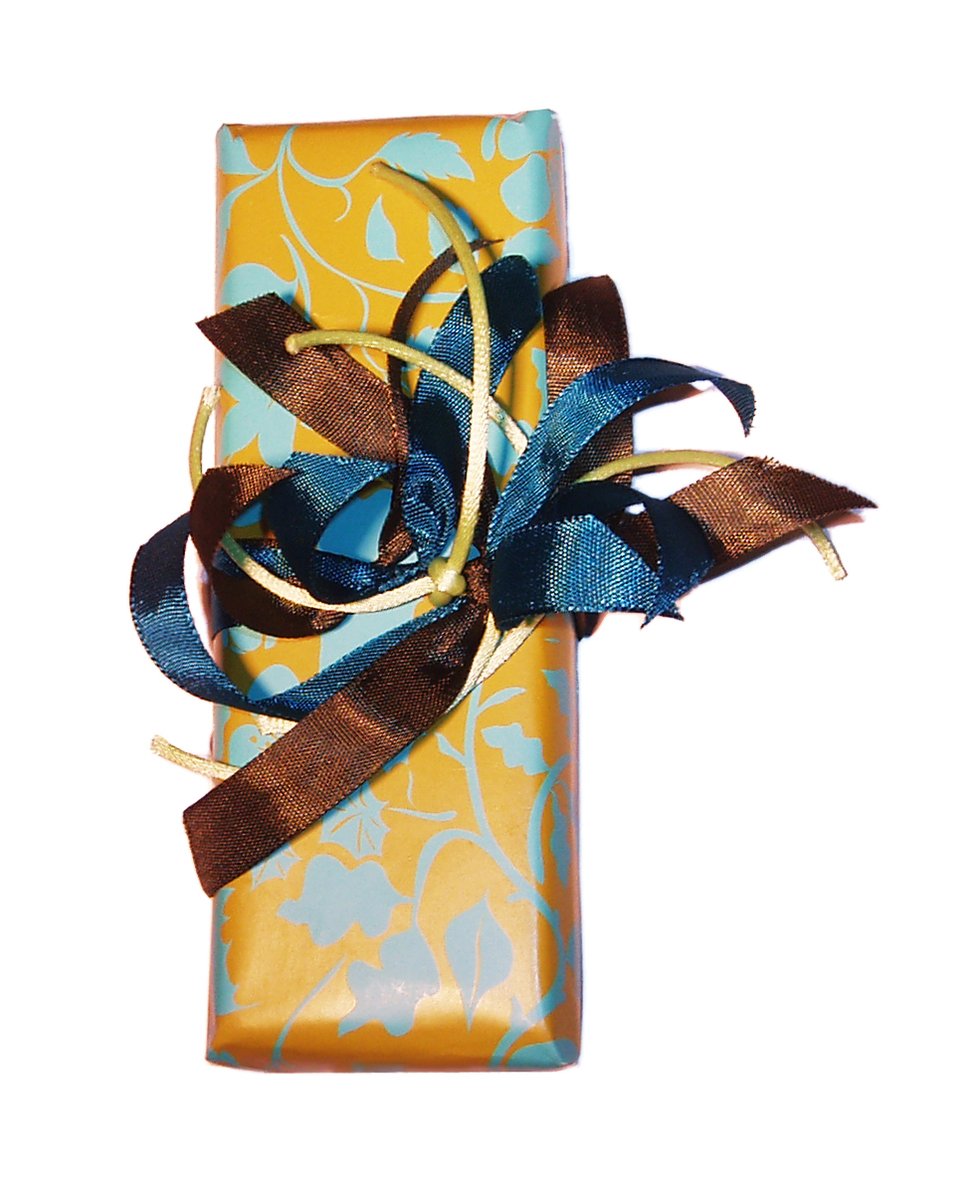 a gift wrapped in a yellow wrapper with ribbons