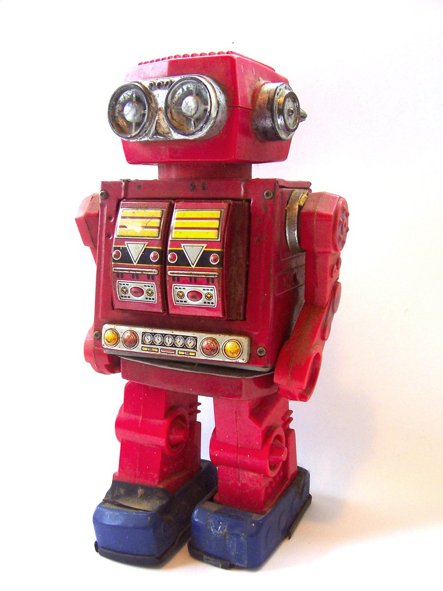 a red robot toy has two eyeballs on his head