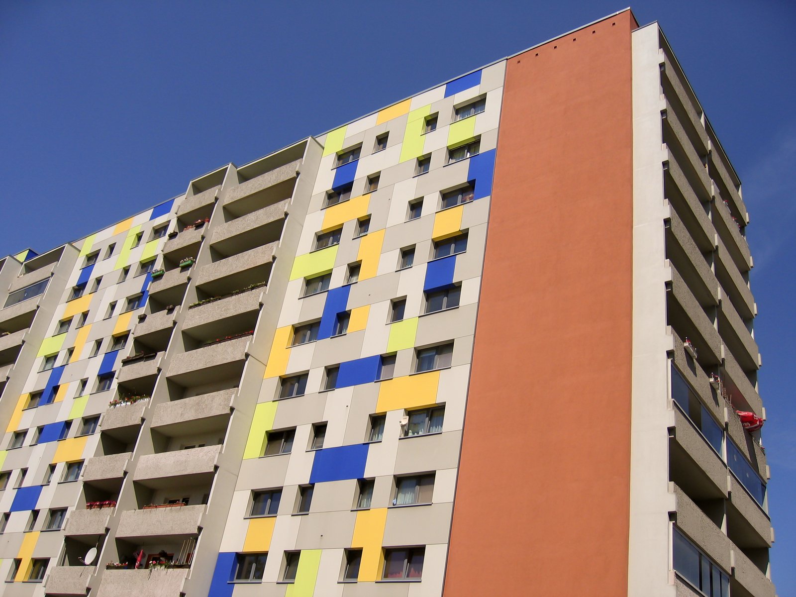 a tall multi - colored building with a sky background