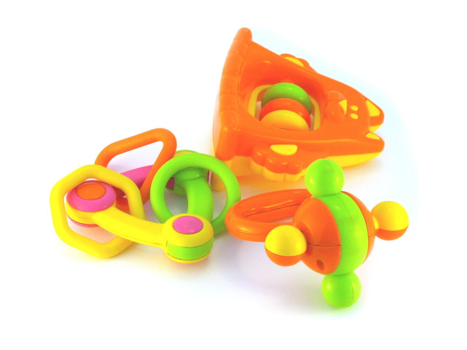 three plastic toys are on a white surface